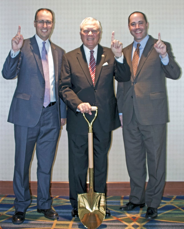 Figure 2: Georgia’s Governor Nathan Deal proudly displays the state’s Gold Shovel award. He’s joined by Department of Economic Development Commissioner Chris Carr (right) and Deputy  Commissioner of Global Commerce Tom Croteau (left).