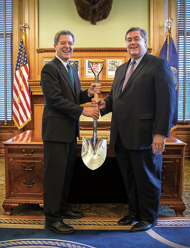 Figure 4: Kansas Governor Sam Brownback (left) and Interim Kansas Commerce Secretary Michael Copeland pose with the state’s Silver Shovel award.